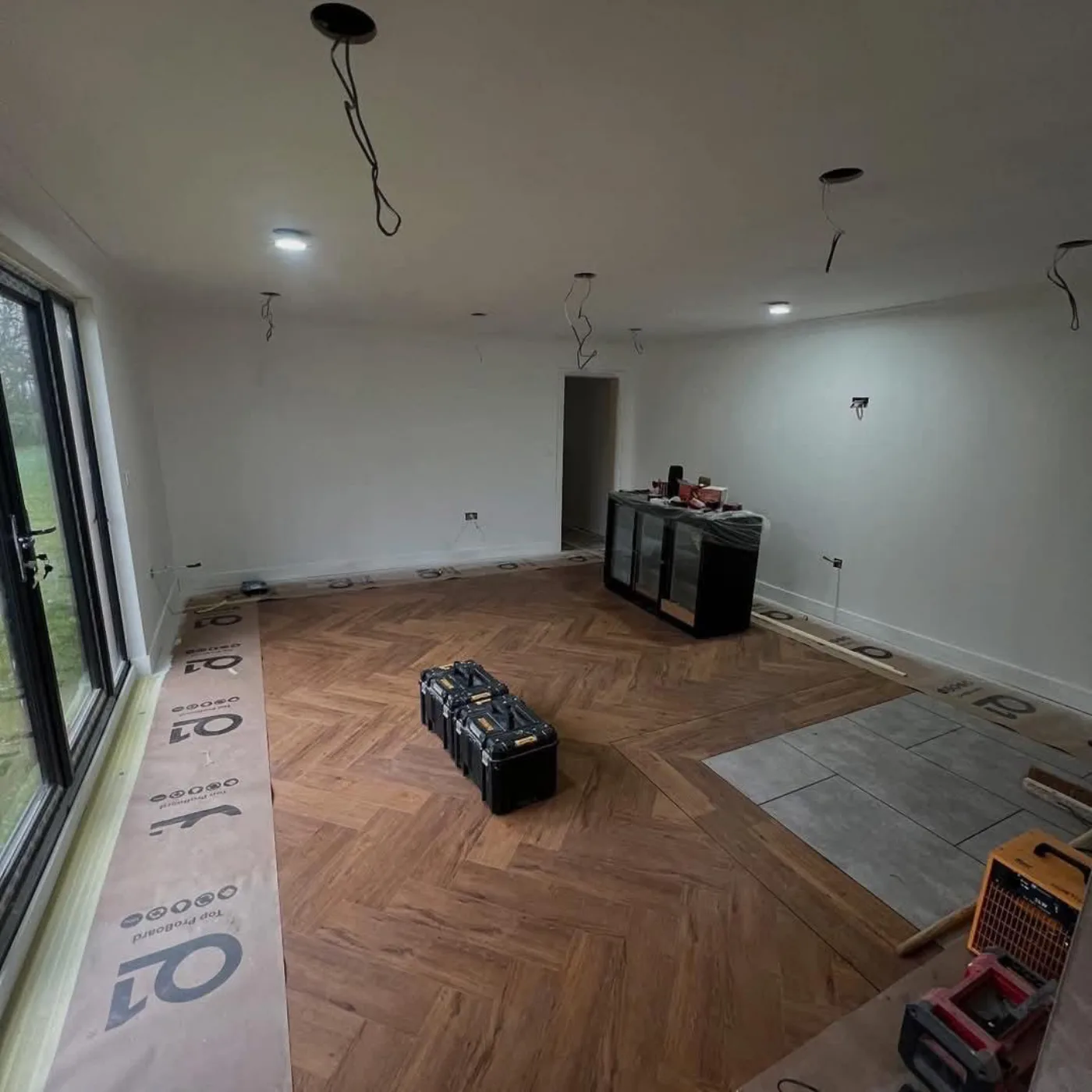 Herringbone flooring installation in progress