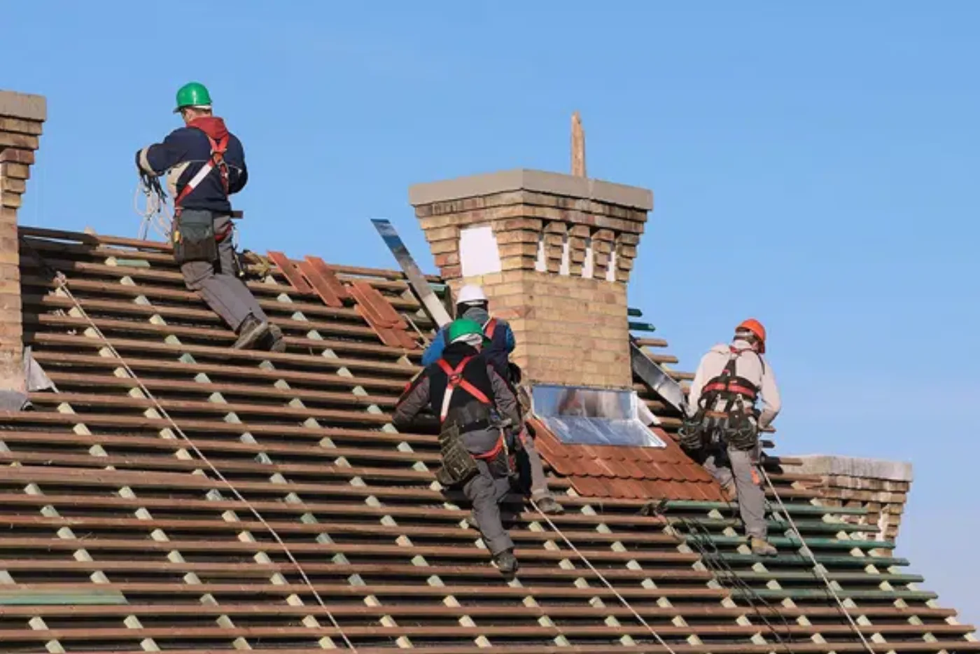 Roofing team re-roofing a tiled roof